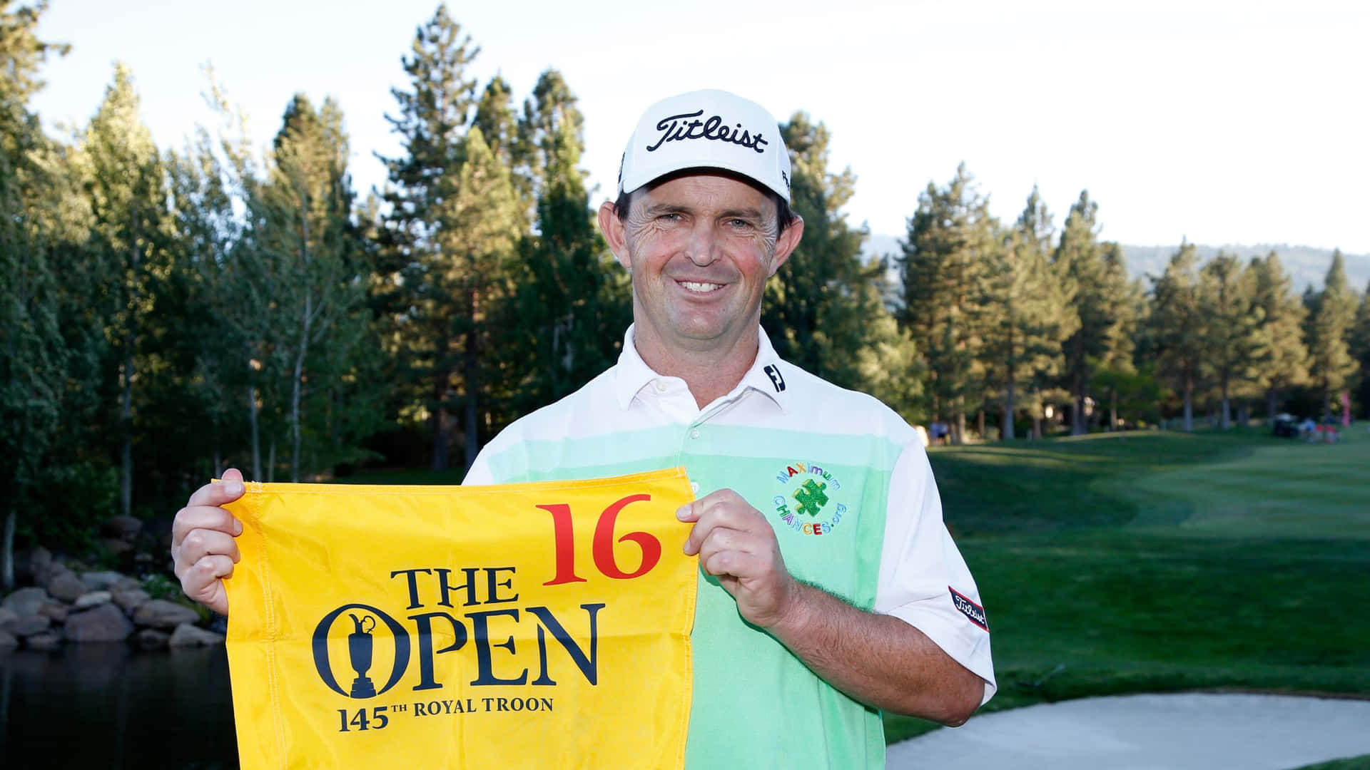 Caption: Professional Golfer Greg Chalmers Holding a Yellow Banner Wallpaper