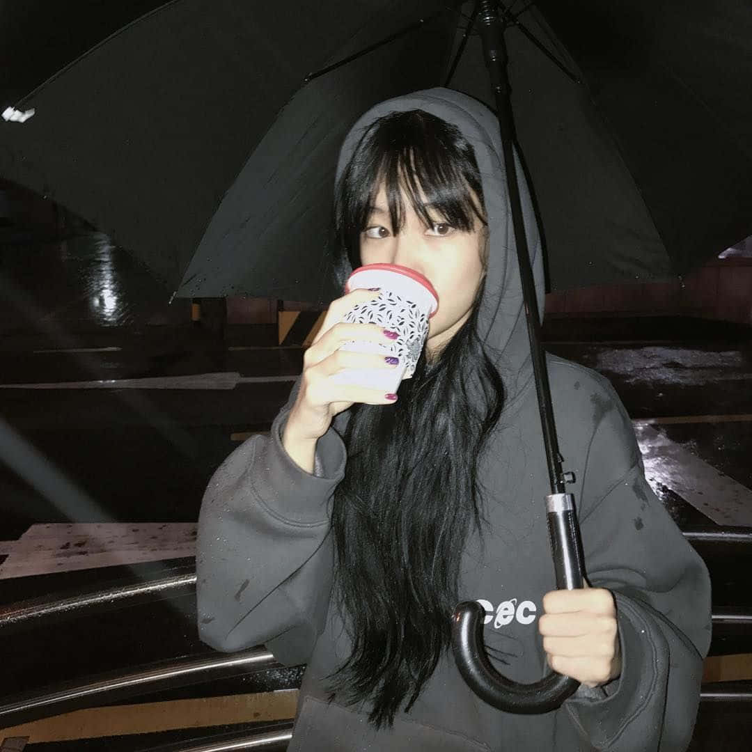 A Girl Holding An Umbrella