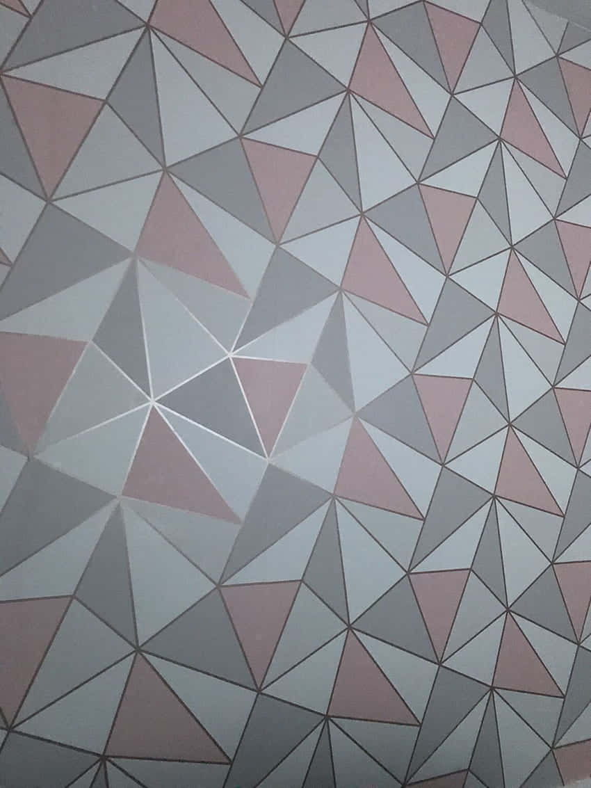 A Pink And Grey Geometric Wall With A White Border Wallpaper