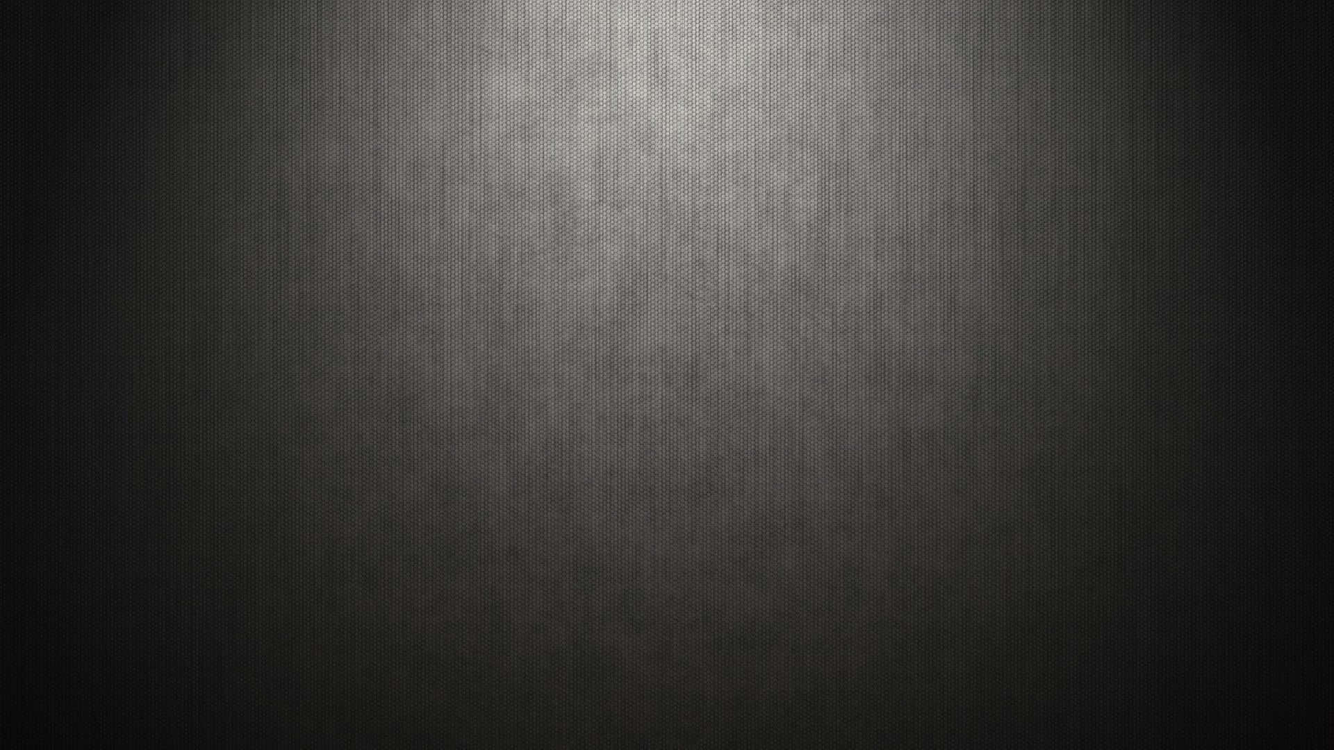 A Black Metal Background With A Light Shining On It