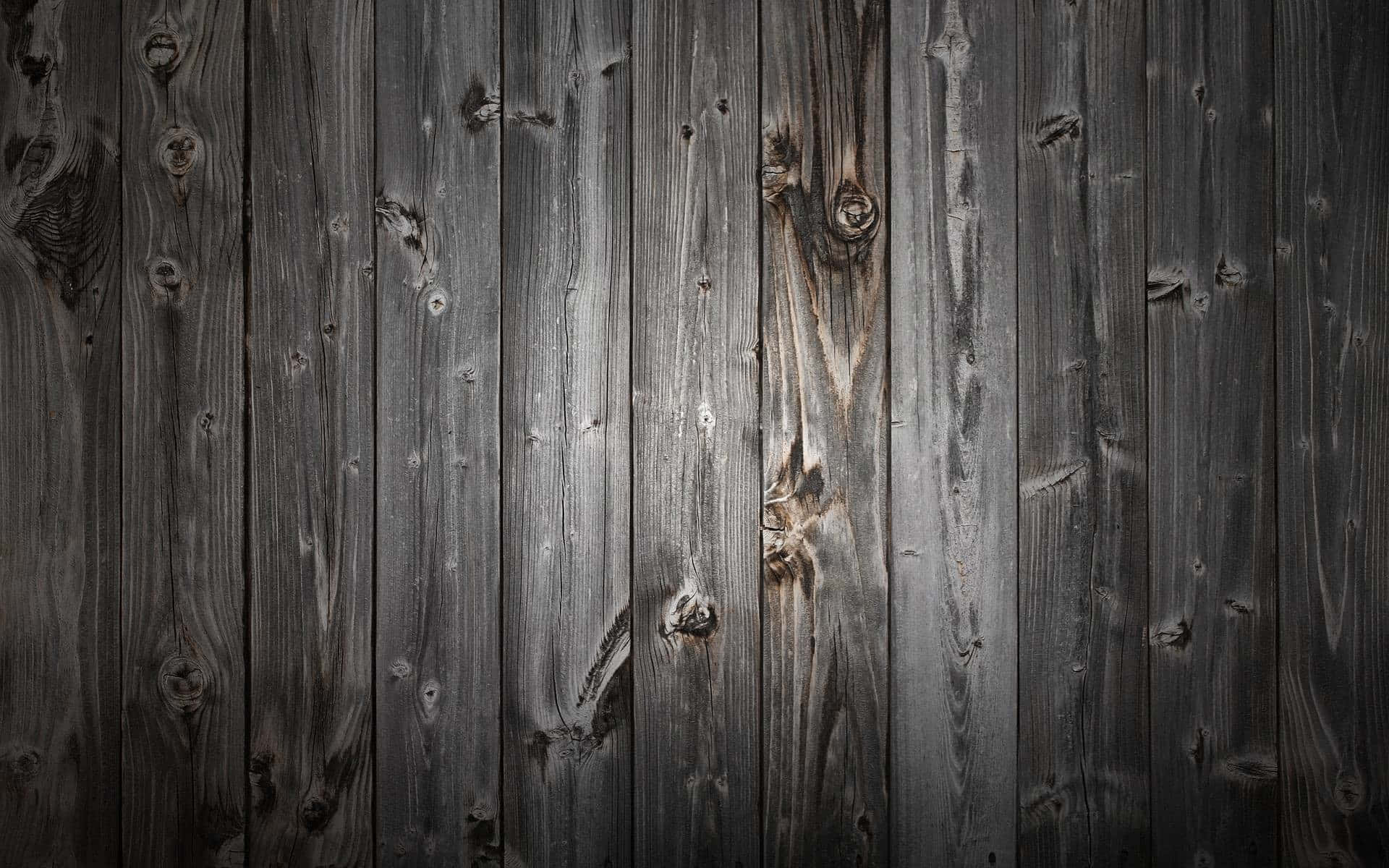 A Close Up Of A Wooden Wall With Dark Paint