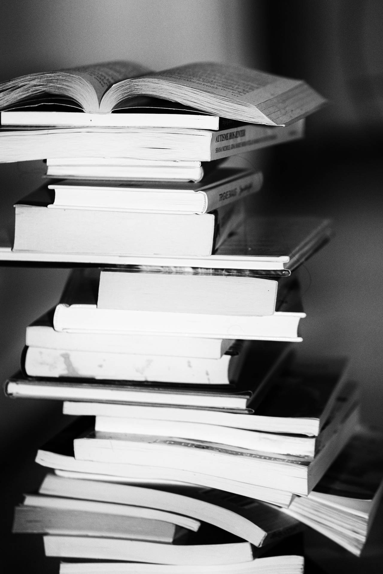 Greyscale Photo Of A Pile Of Books Wallpaper