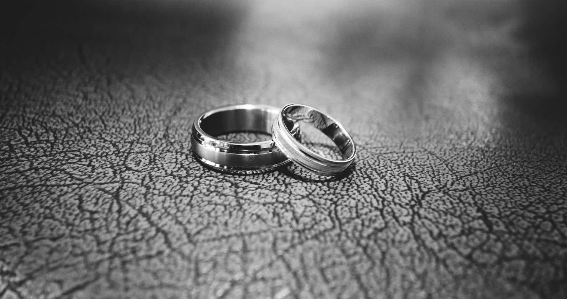 Elegant Greyscale Wedding Ring on Fine Leather Wallpaper