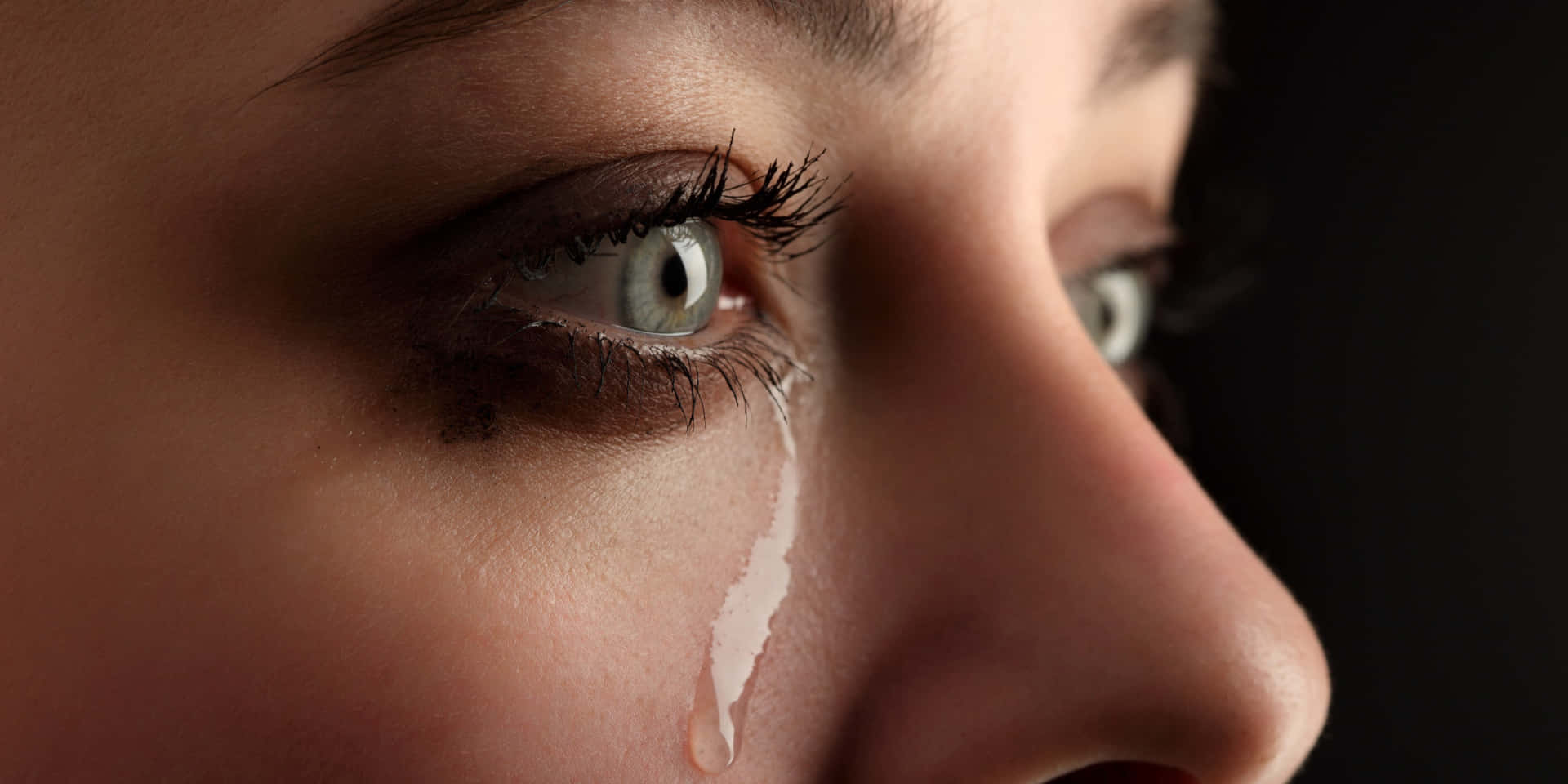 A Woman Is Crying With Her Eyes Closed