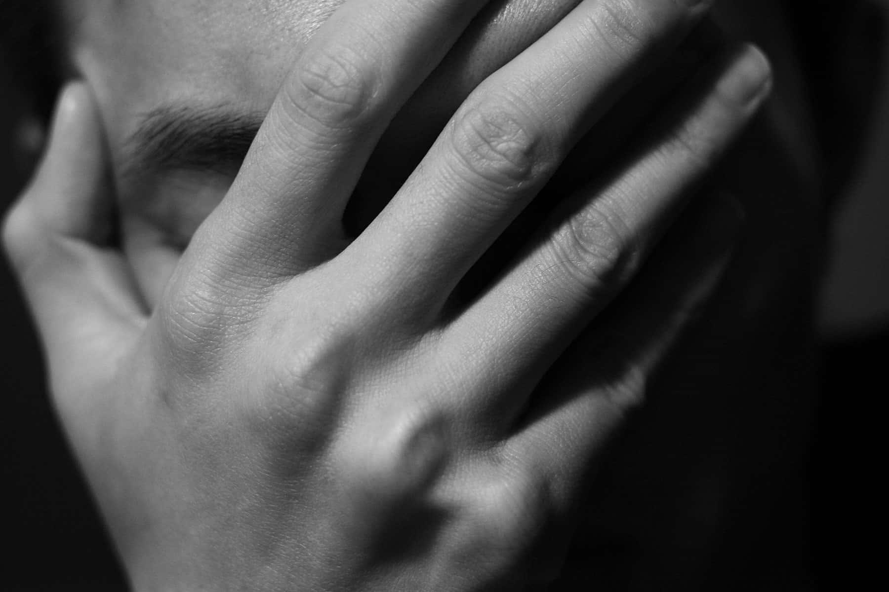 A Man Covering His Face With His Hands