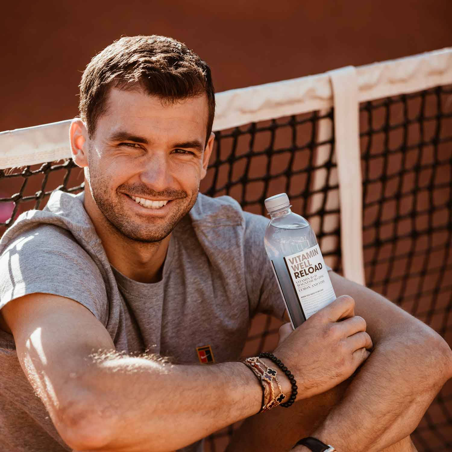 Grigor Dimitrov Smiling With Water Bottle Wallpaper