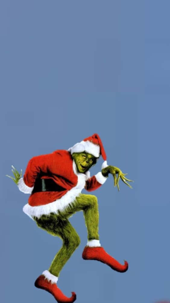 "a Festive Grinch Stealing A Christmas Present Off Of A Stack Of Presents!" Wallpaper