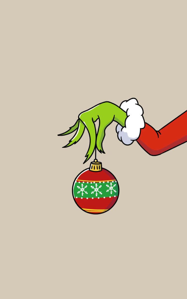 Download Grinch Hand Holding Christmas Ornament Wallpaper | Wallpapers.com