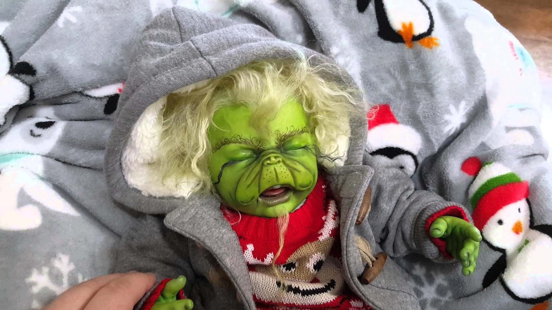 A Baby Dressed Up As The Grinch