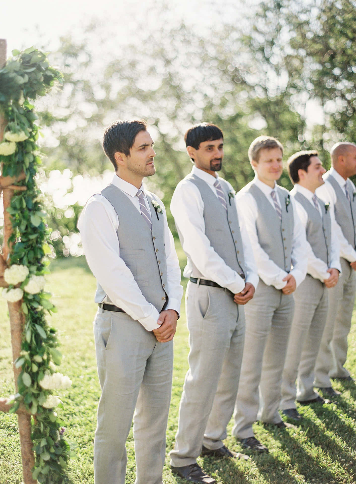 Professional and stylish groomsmen looking suave in their matching suits