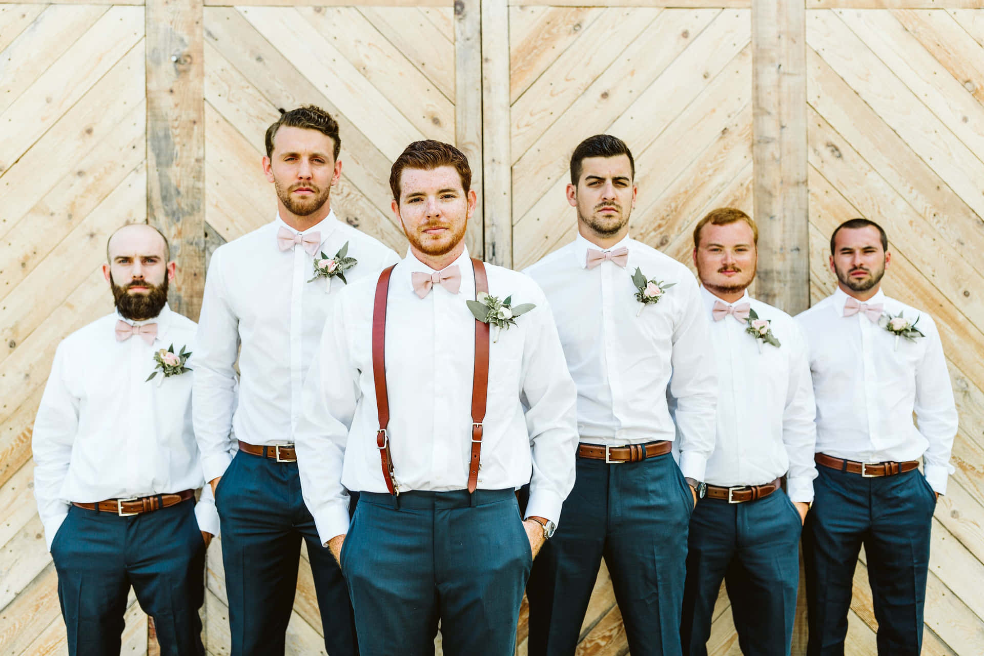 Groom surrounded by his groomsmen at a wedding