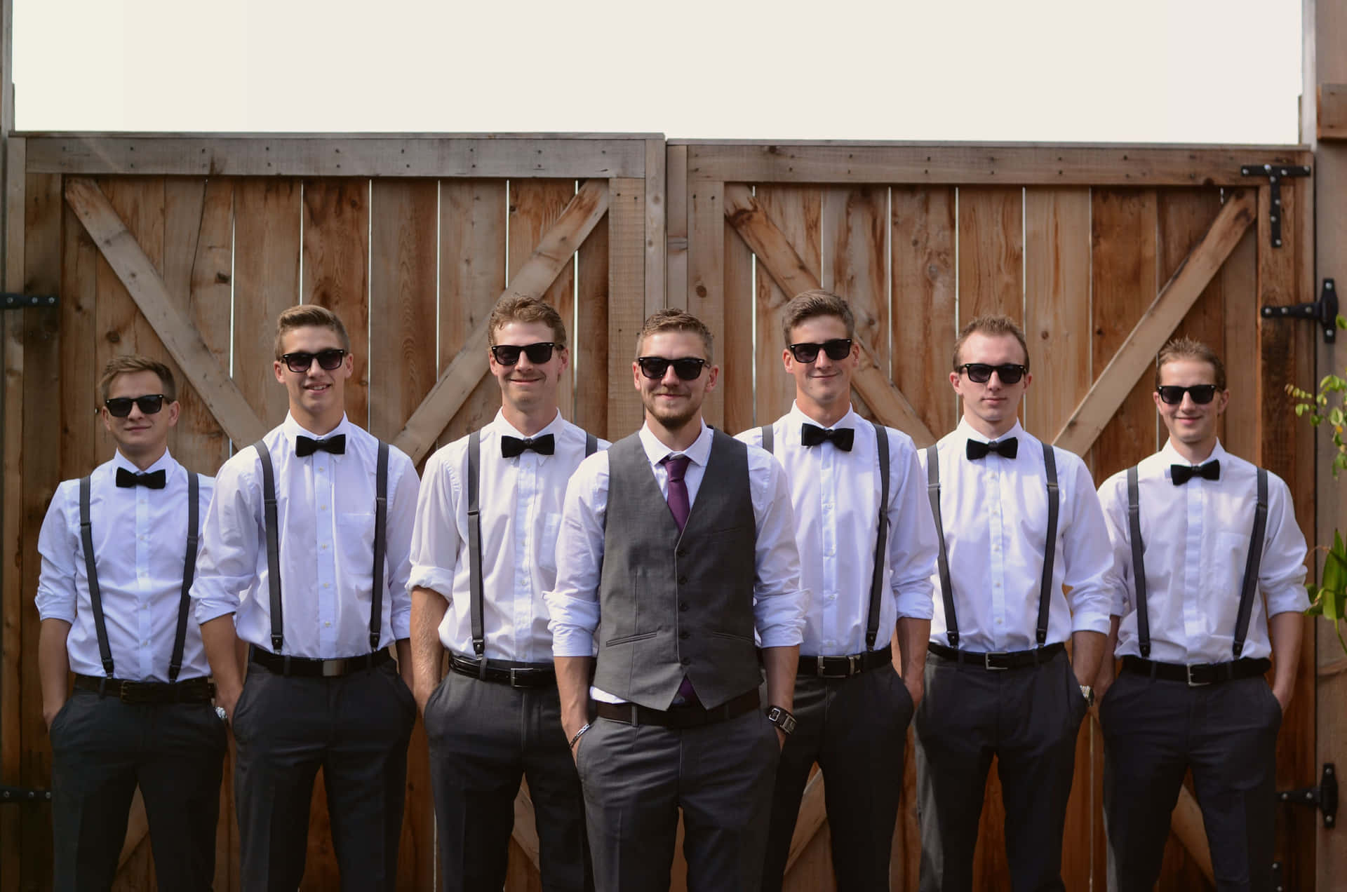 A groom surrounded by his groomsmen on the happiest day of his life
