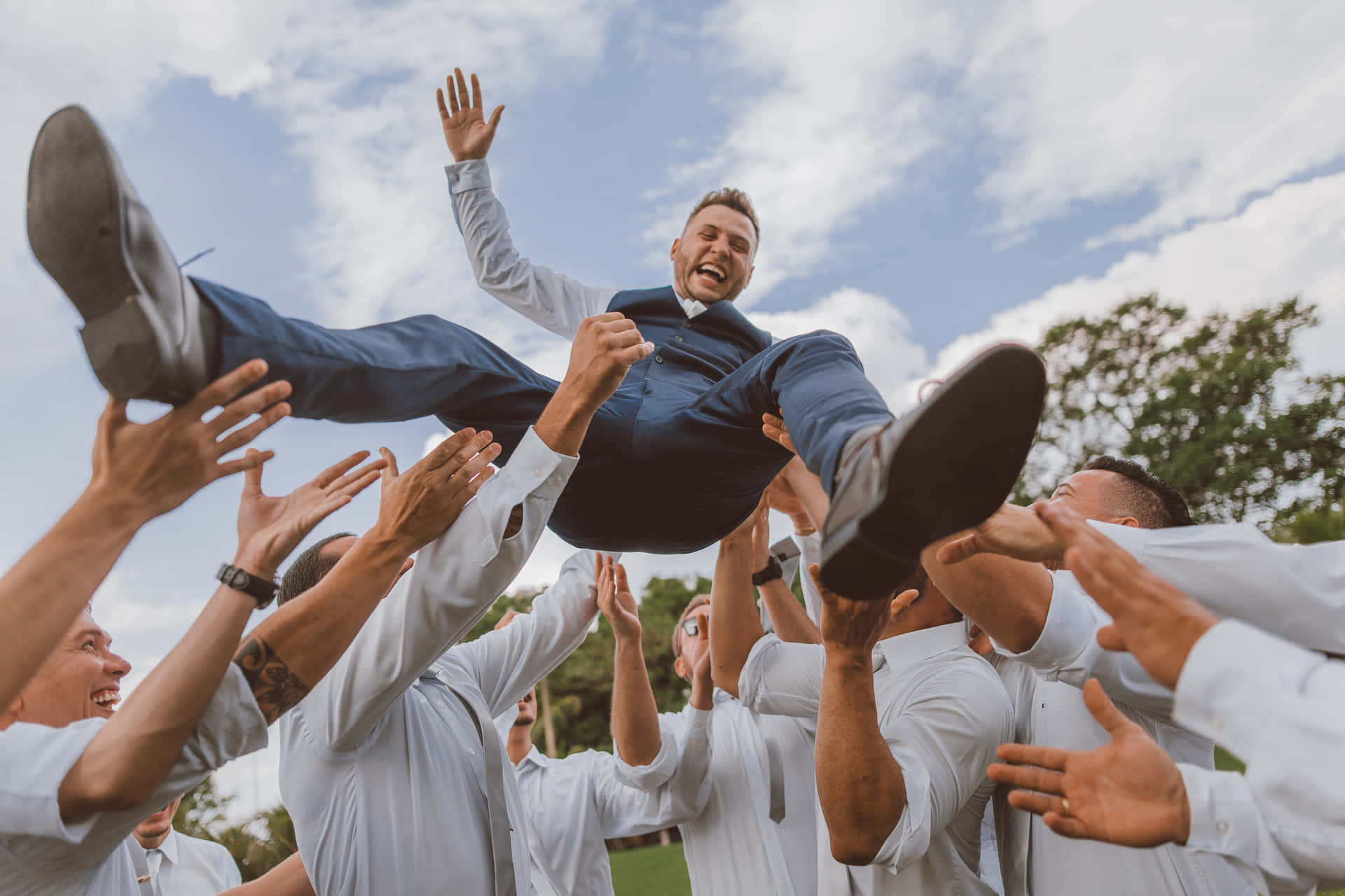 A Group of Groomsmen Celebrating at a Wedding