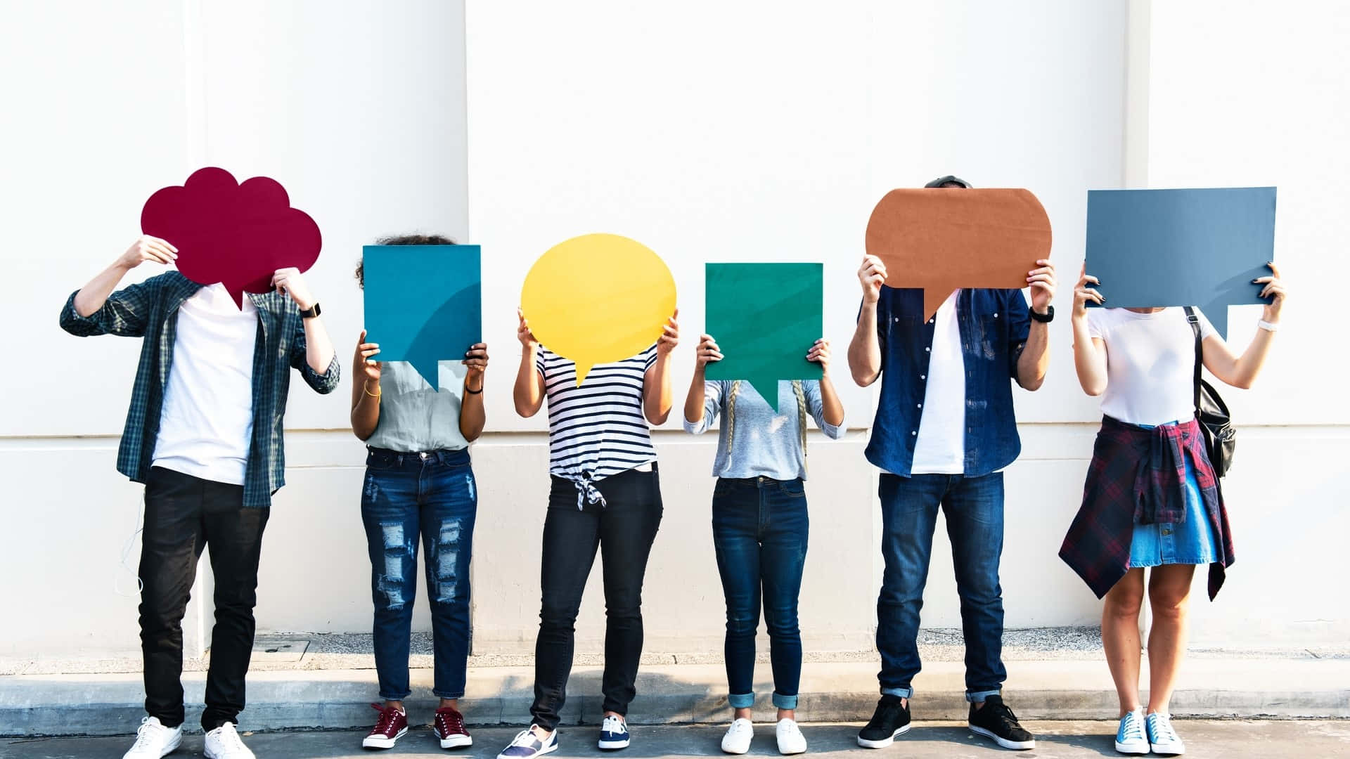 Group Holding Colorful Speech Bubbles Wallpaper