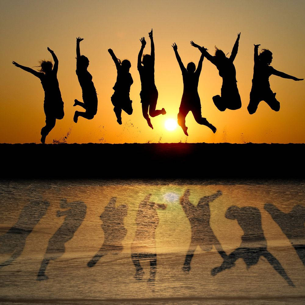 Group Jump Shot With Shadows Sunset Wallpaper