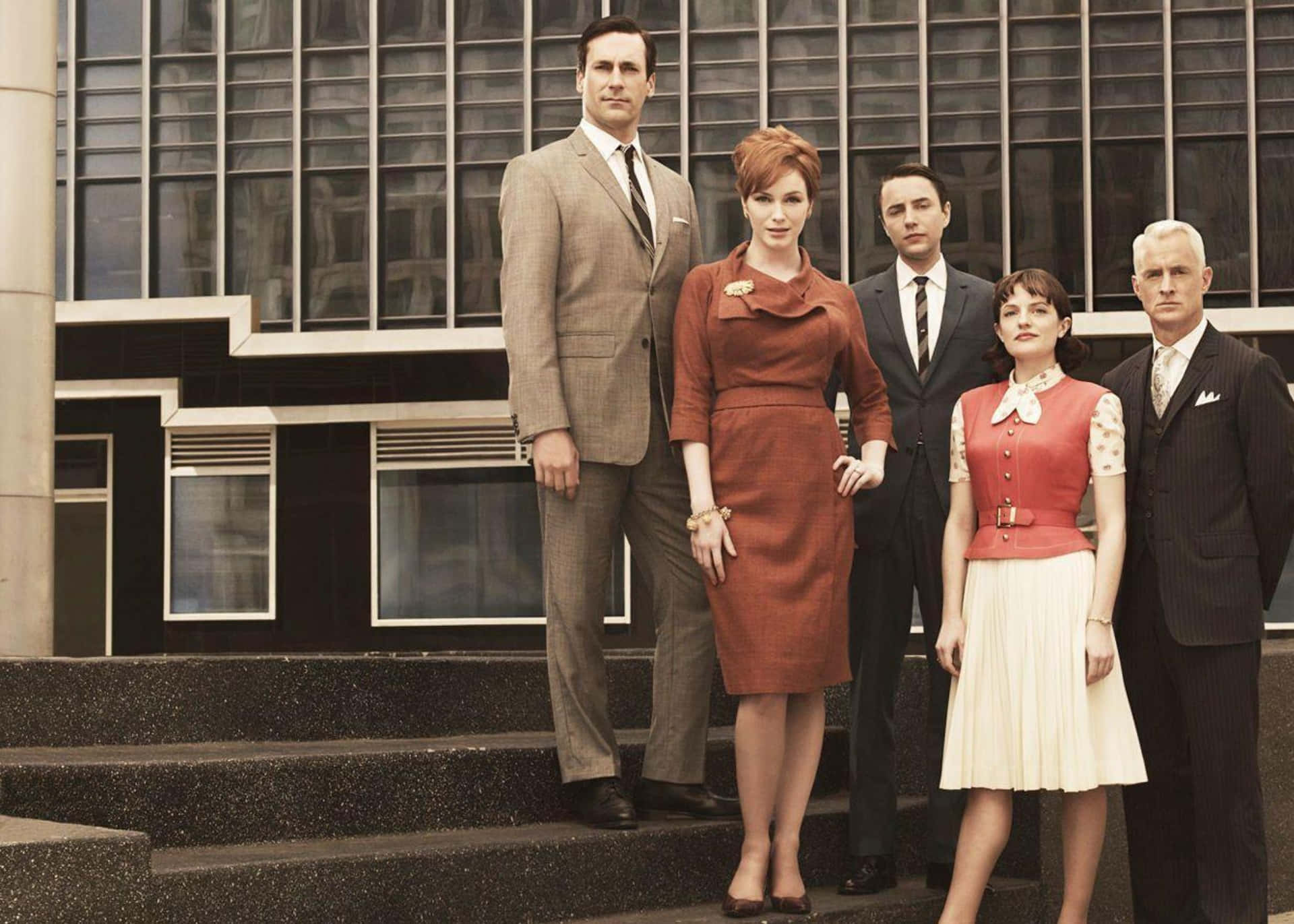 Group Of Mad Men Characters In Iconic Office Setting Wallpaper