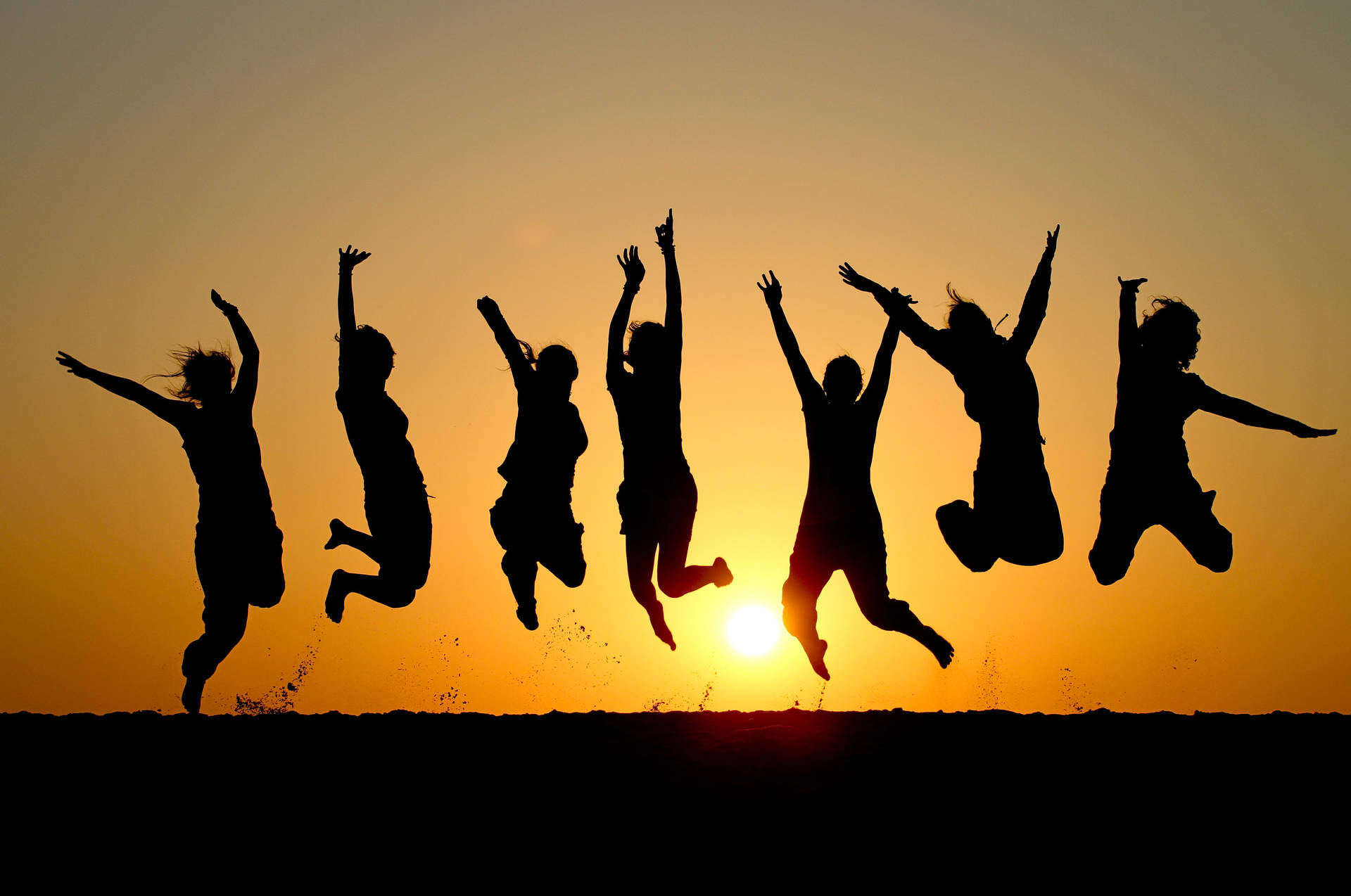 Group Of People Jumping In The Air Wallpaper
