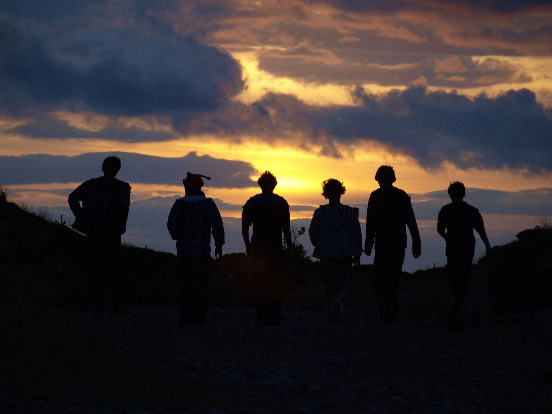 Group Silhouettes On Mountain Top Wallpaper