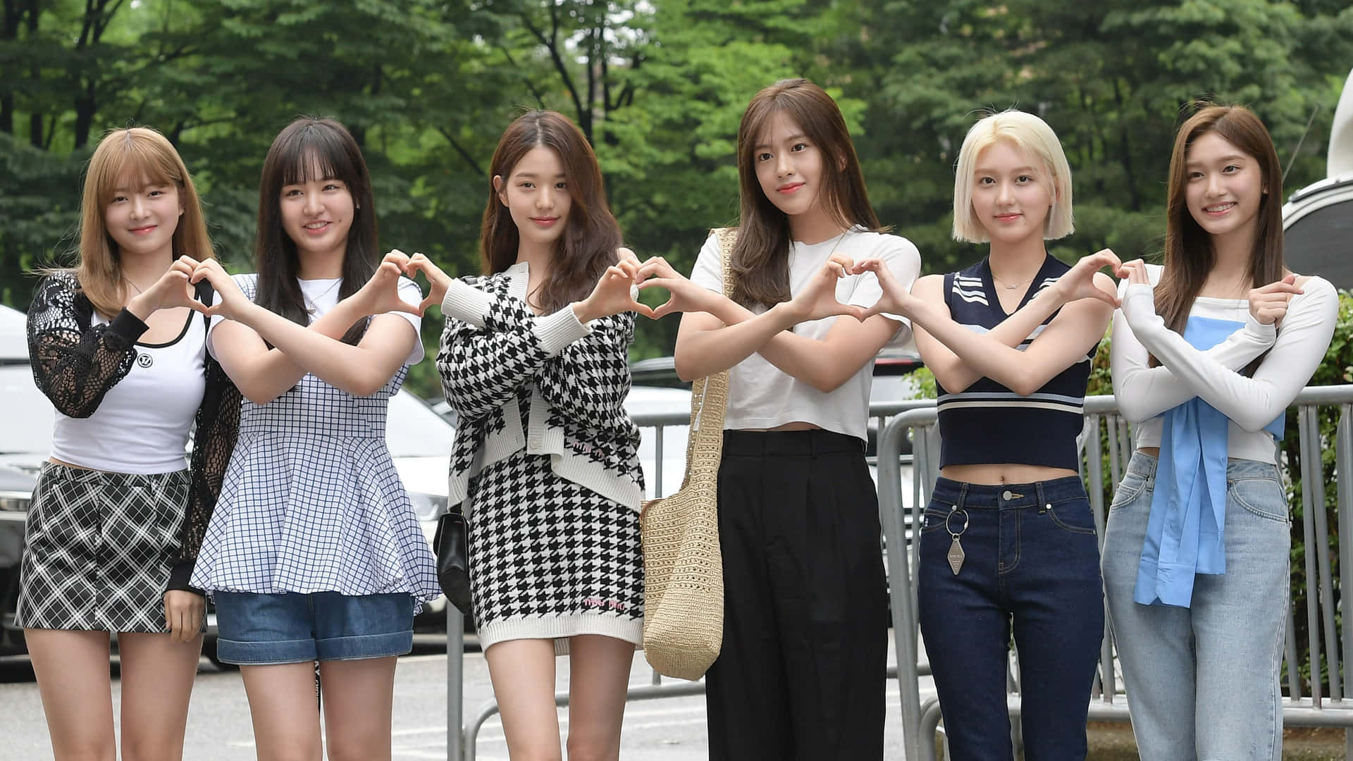 Groupof Friends Making Heart Signs Outdoors Wallpaper