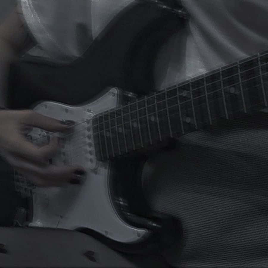 Grunge_ Guitarist_in_ Grey Wallpaper
