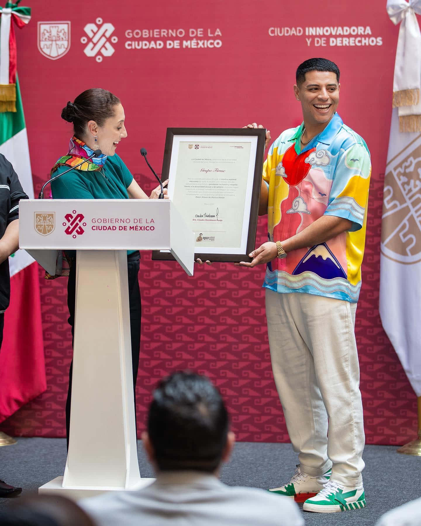A Man And Woman Are Standing At A Podium With A Certificate Wallpaper