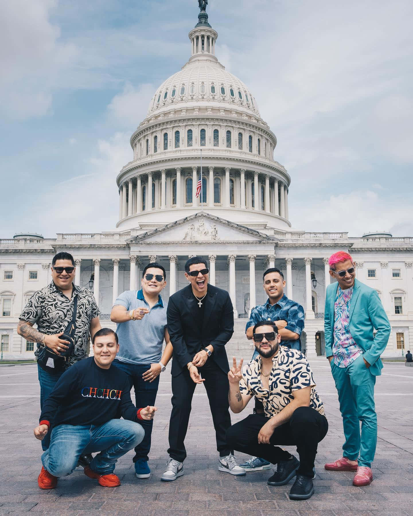 A Group Of Men Posing In Front Of The Capitol Building Wallpaper