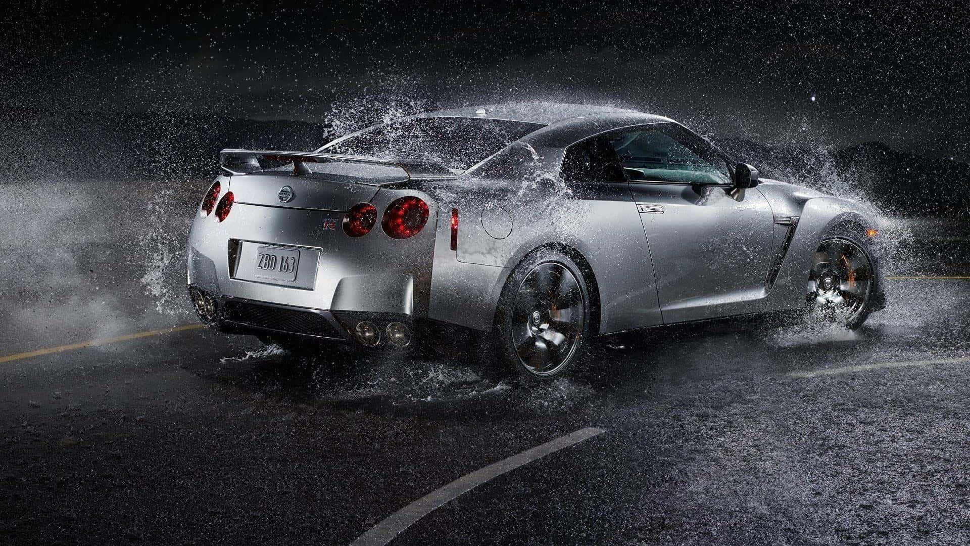 A Silver Sports Car Splashing Water On The Road Wallpaper