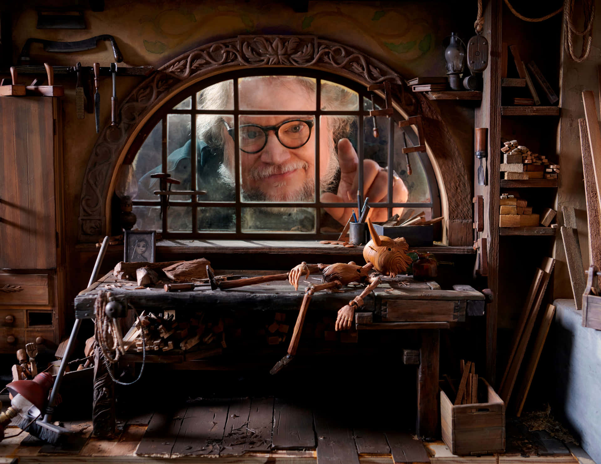 Guillermo Del Toro's Pinocchio sitting atop a circus caravan in the moonlight Wallpaper