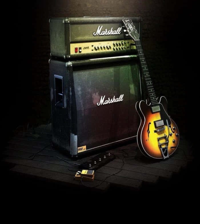 An electric guitar rests next to its amp Wallpaper
