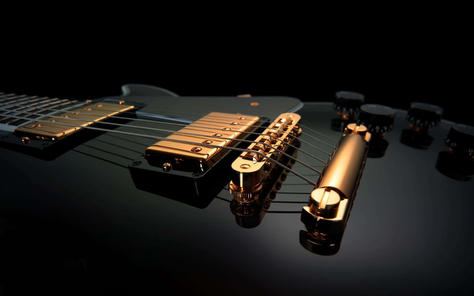 A Black Guitar With Gold Hardware On It