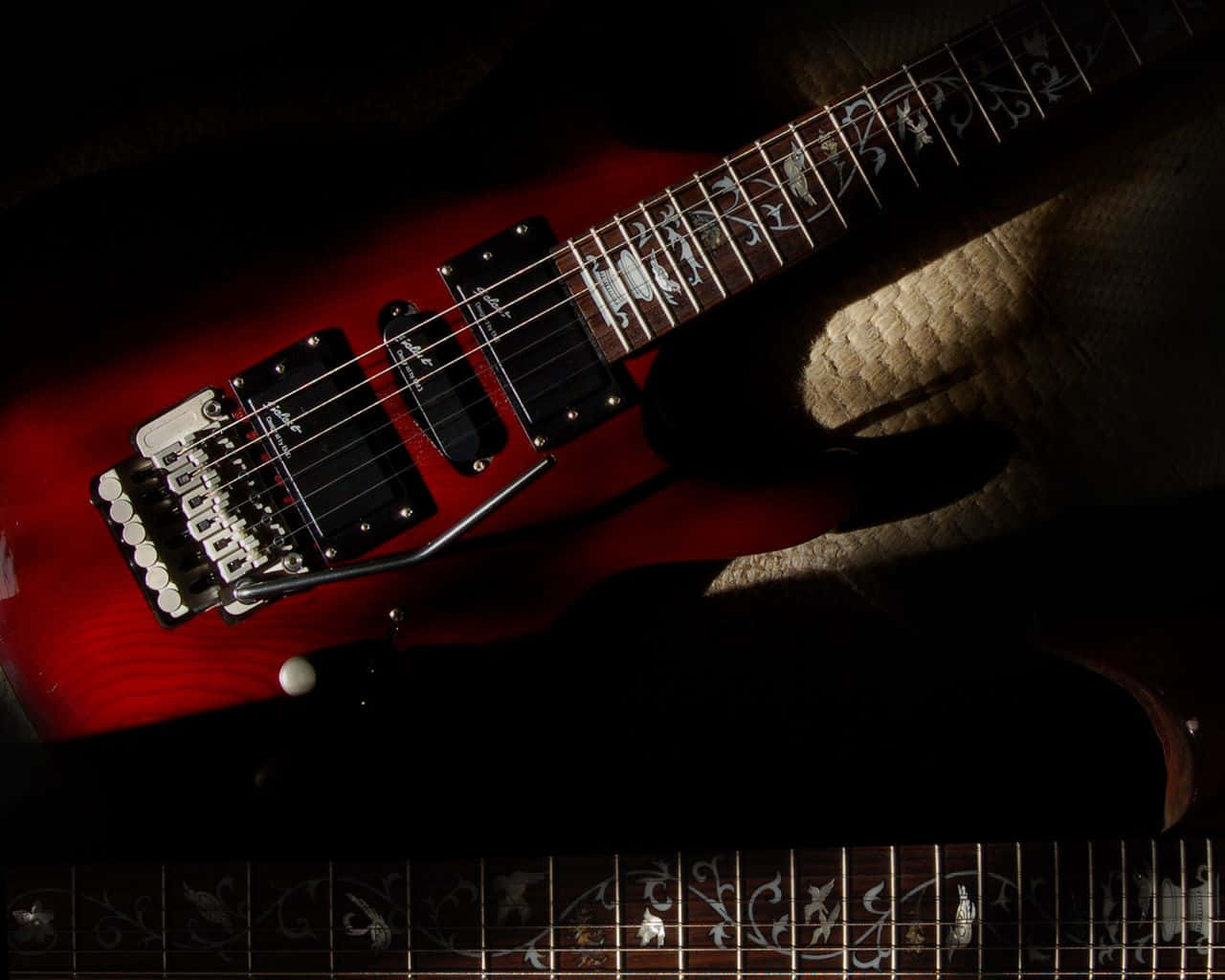 A vintage-style electric guitar against a black backdrop