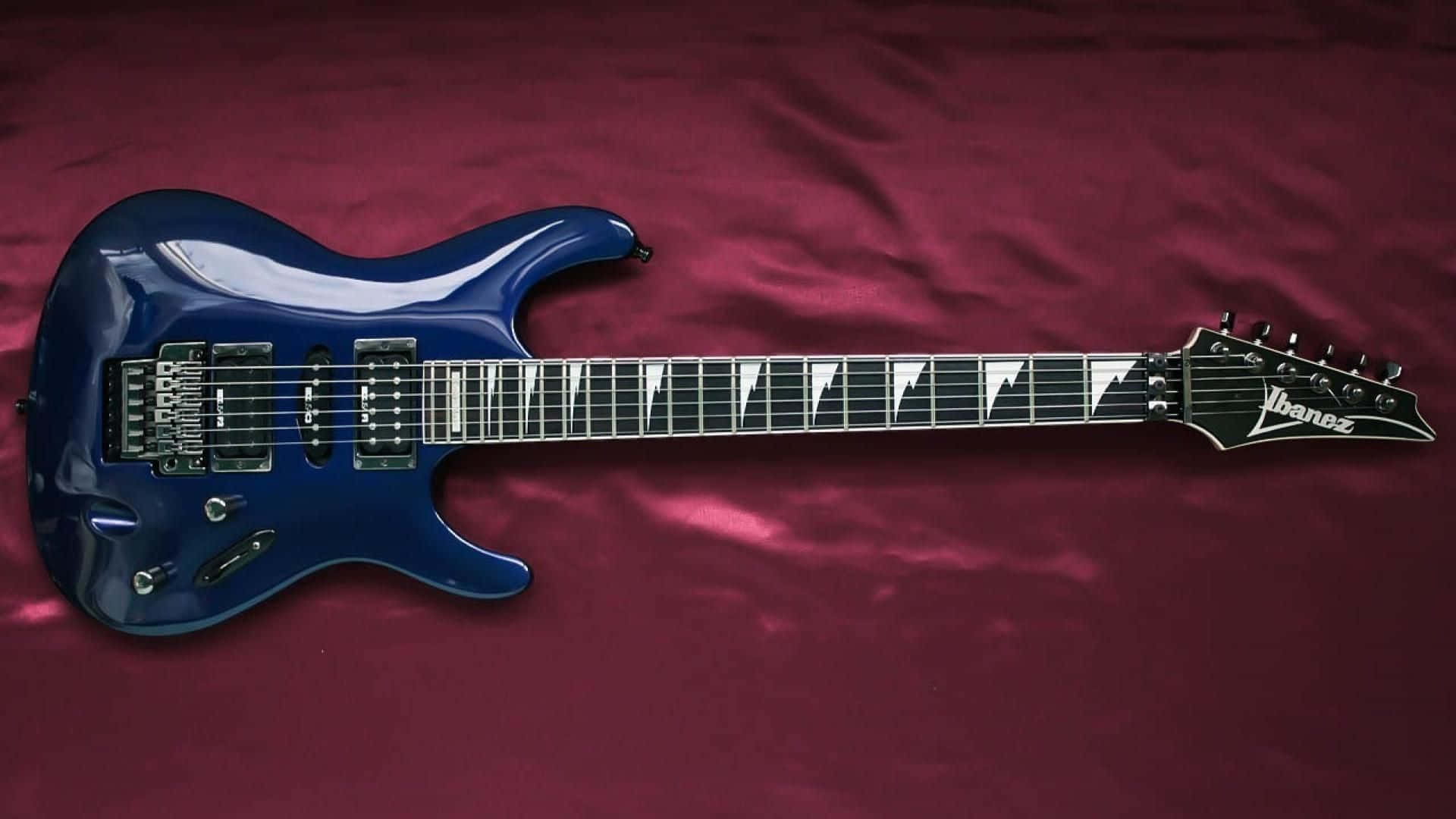A Blue Electric Guitar With A Black Body