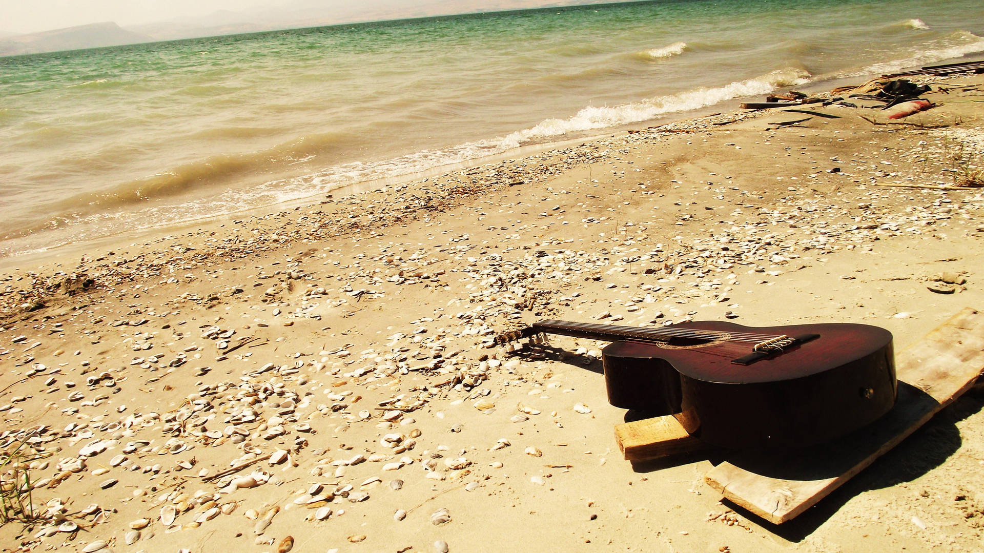 Sunny Beach Vibes with a Guitar Wallpaper