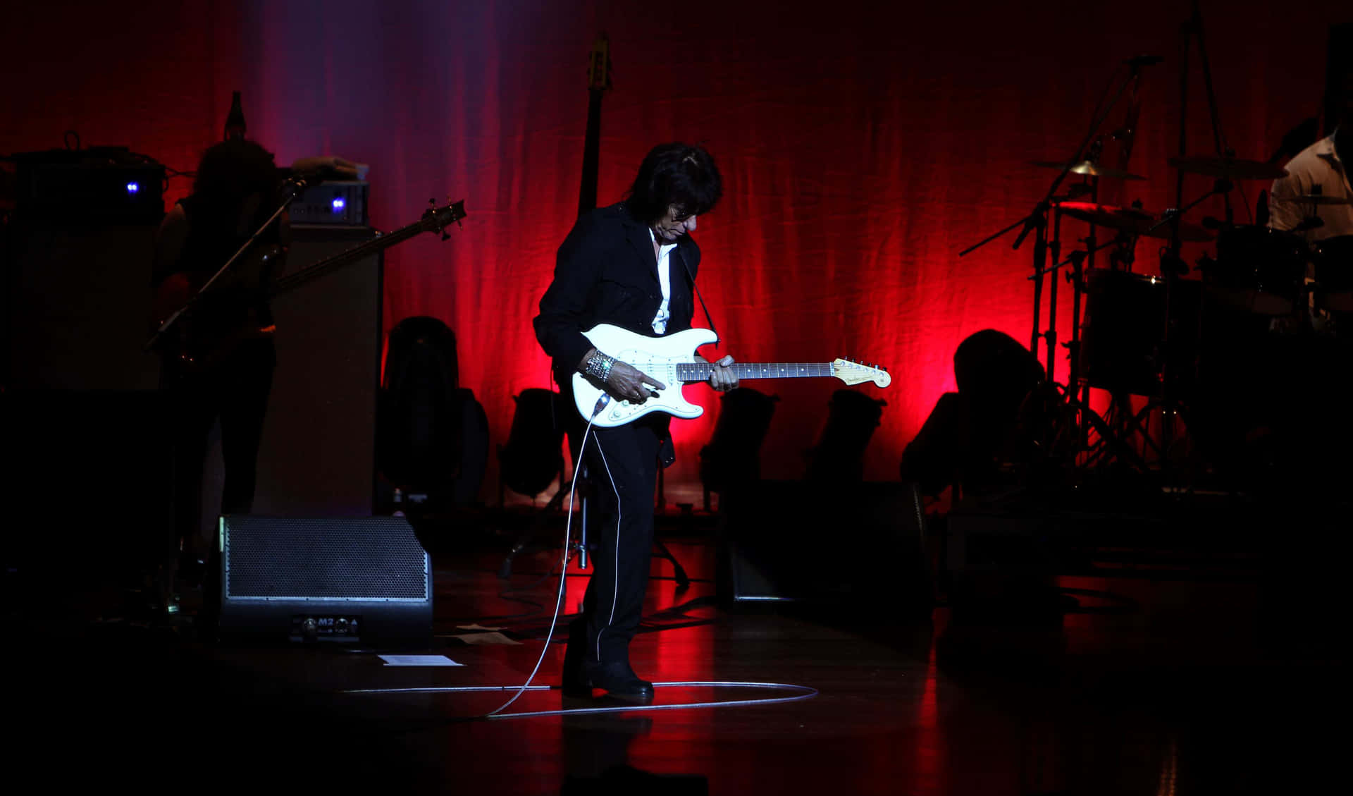 Guitarist Performingon Stage Wallpaper