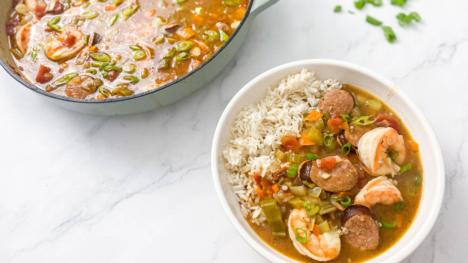 Delectable Gumbo in Pan and Plate with Rice on Marble Surface Wallpaper
