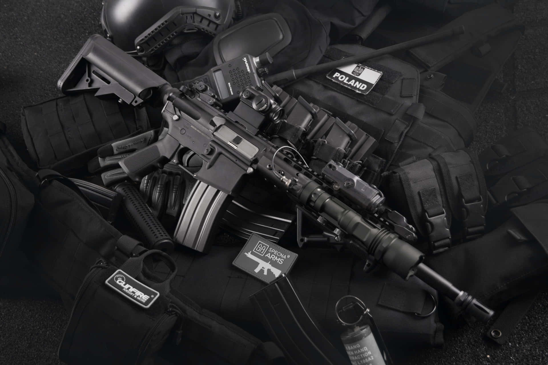 A Black Rifle And Other Equipment On A Black Background