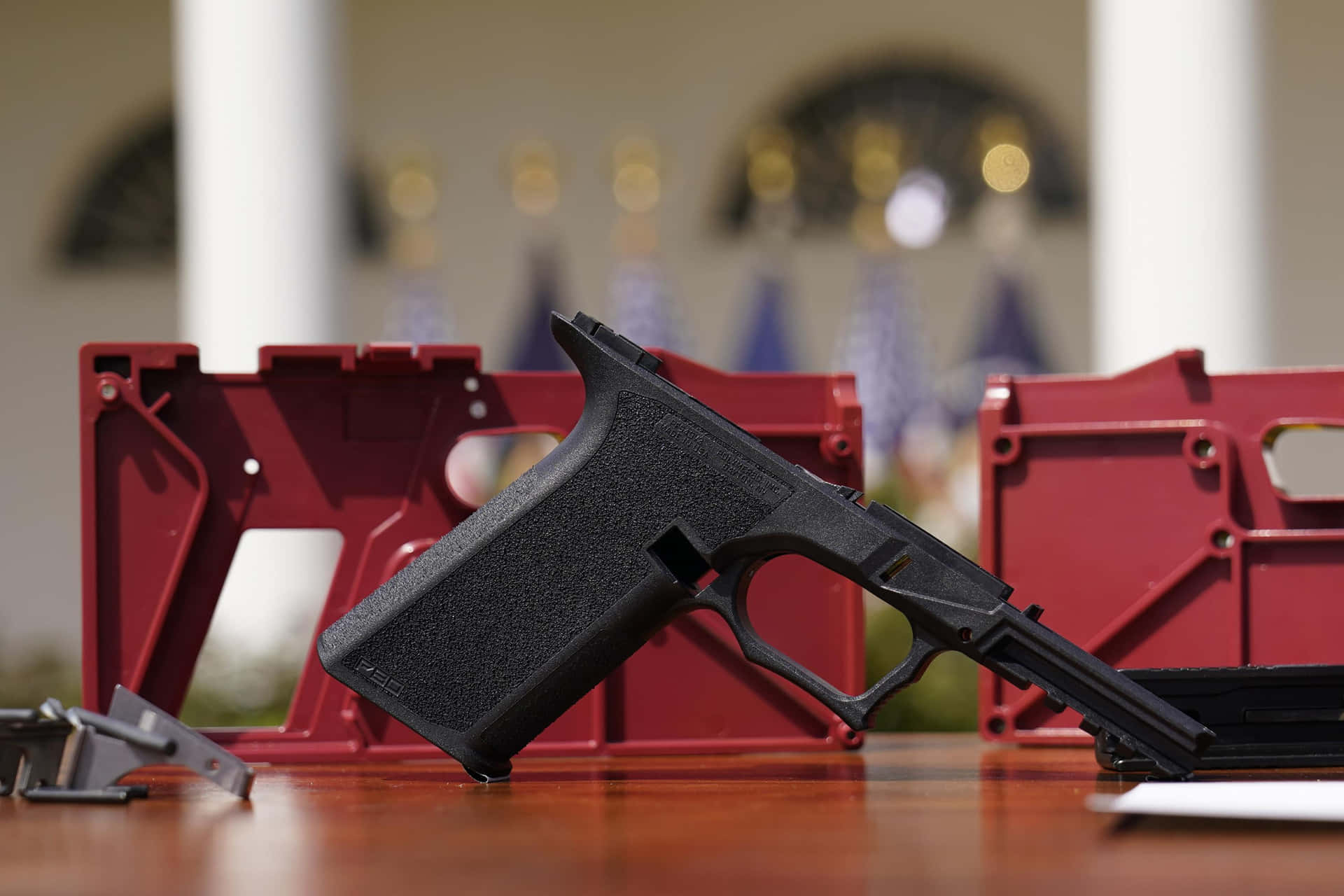 A Gun Is Sitting On A Table Next To A White House