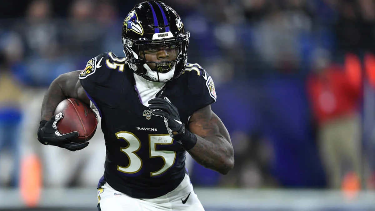 Gus Edwards Ravens Running Back Action Wallpaper