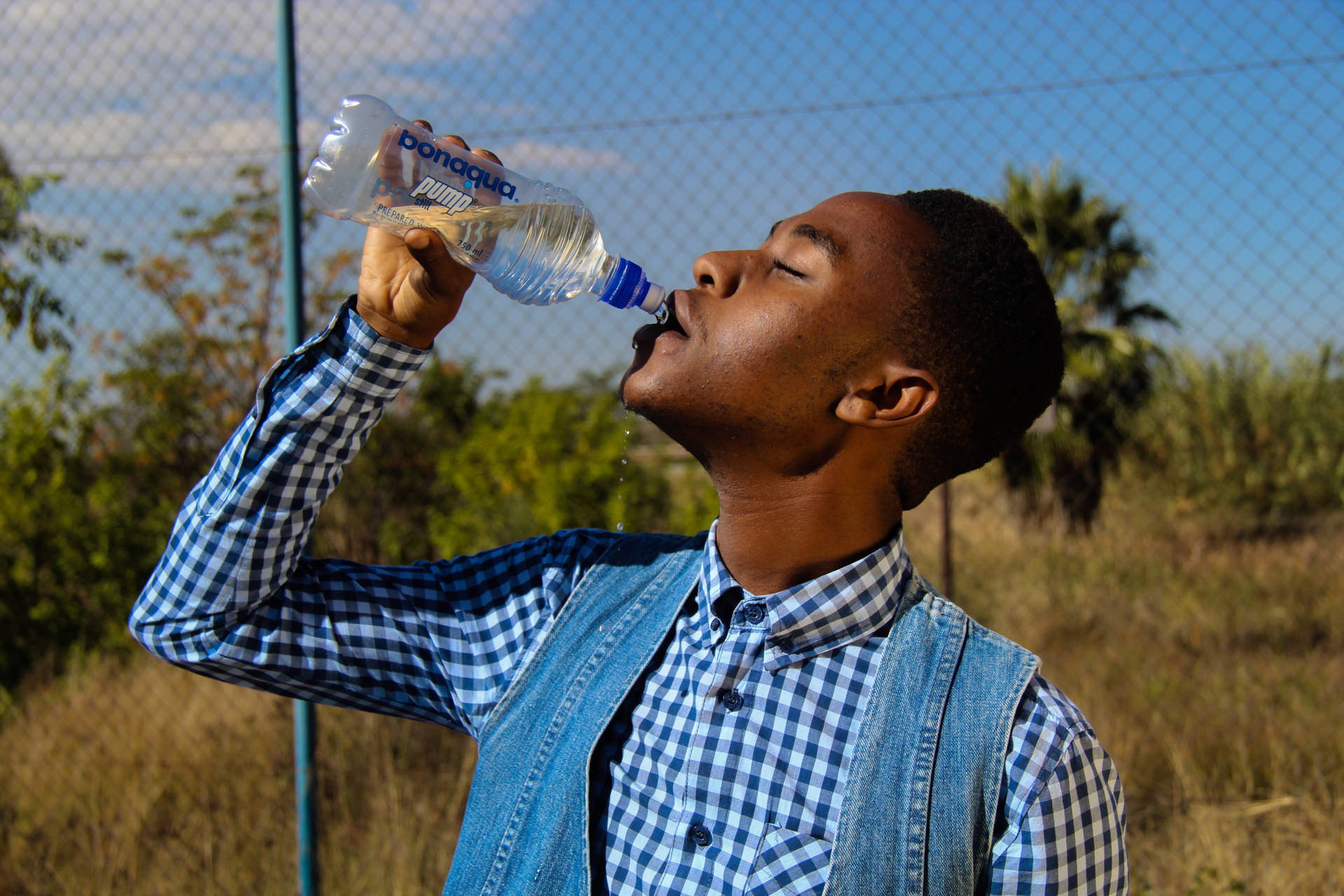 Guy Drinking Water From A Bottle Wallpaper