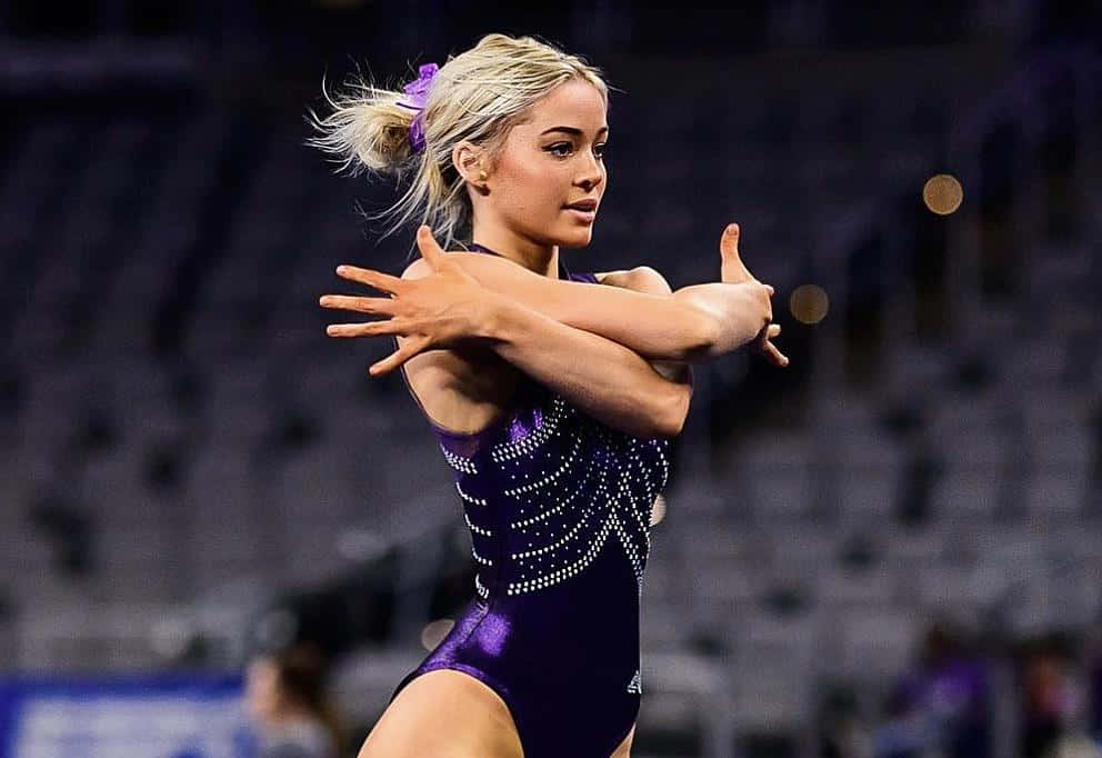 Gymnast Performing Routine Purple Leotard Wallpaper