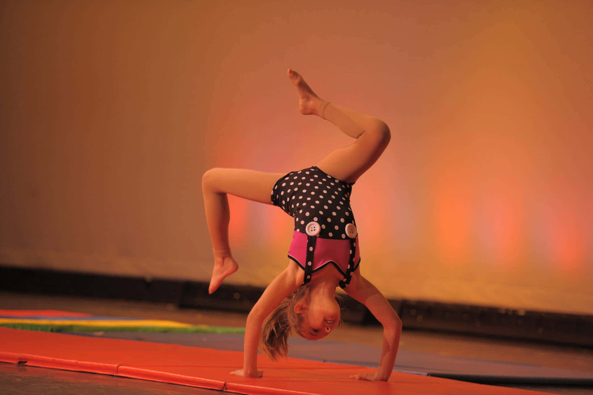 A female gymnast performing on balance beam