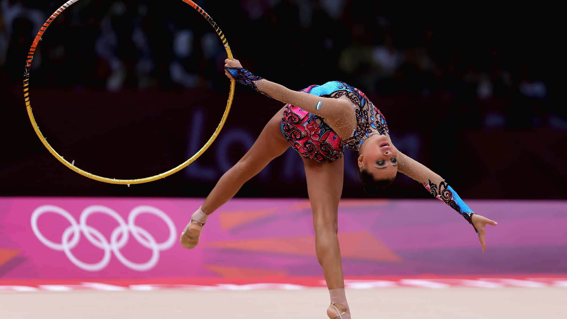 Female gymnast performing artistic gymnastics on balance beam
