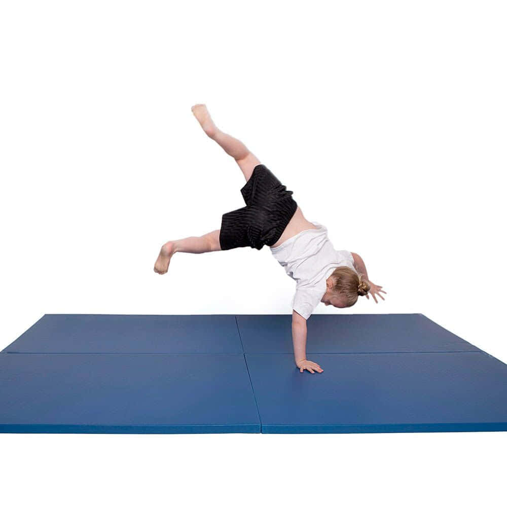 Young Gymnast on Anti-slip Gymnastics Mat Wallpaper