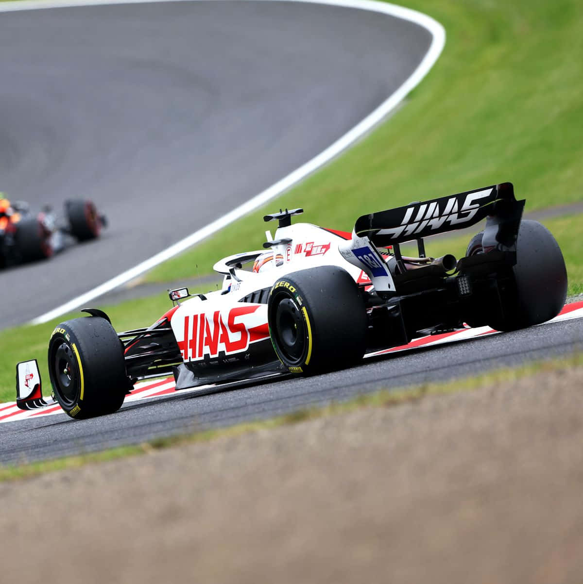 Haas F1 Racing Car Action Wallpaper