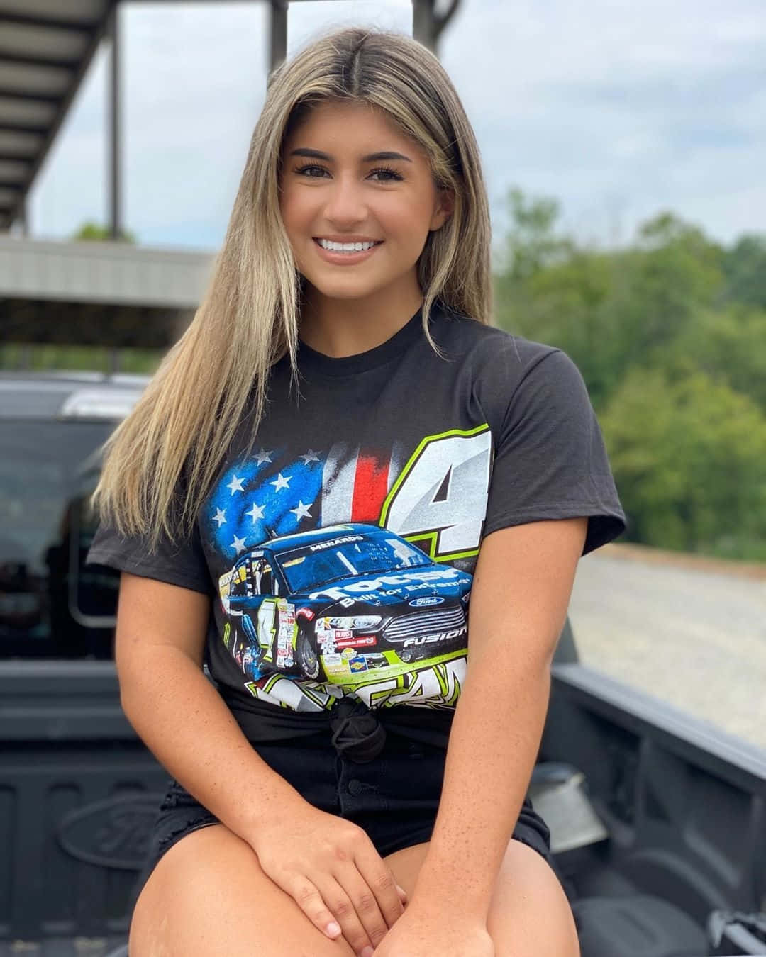 Hailie Deegan Smiling With Racing Tee Wallpaper