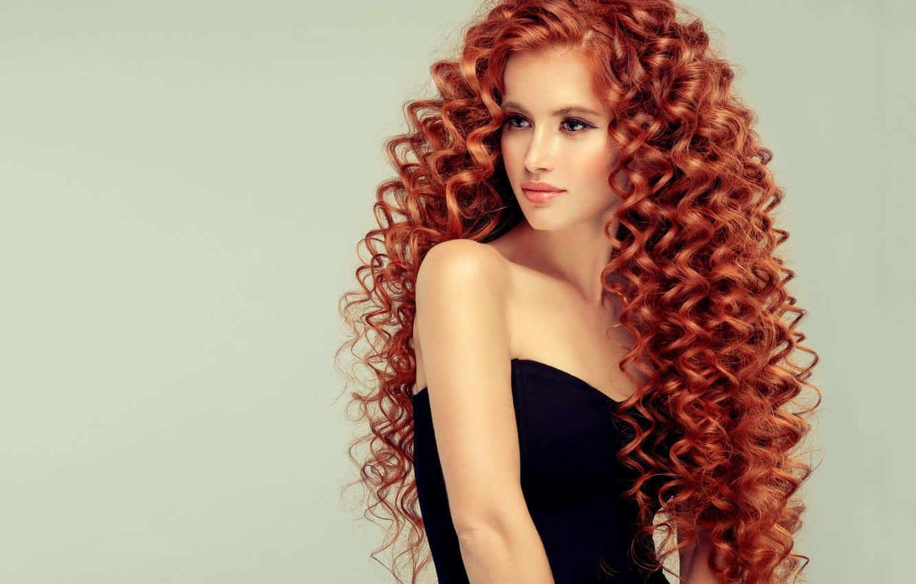 A Woman With Curly Red Hair Posing