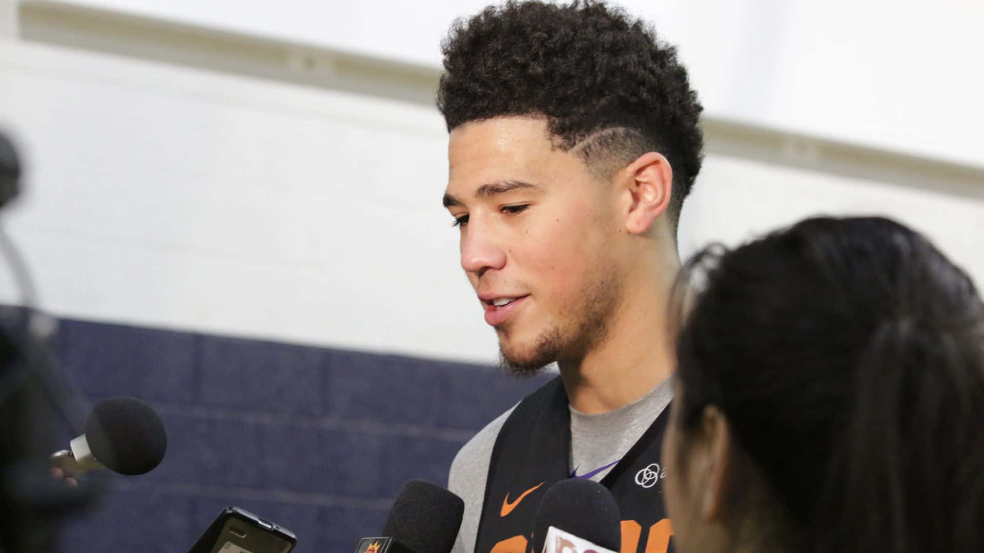 A Basketball Player Talking To Reporters
