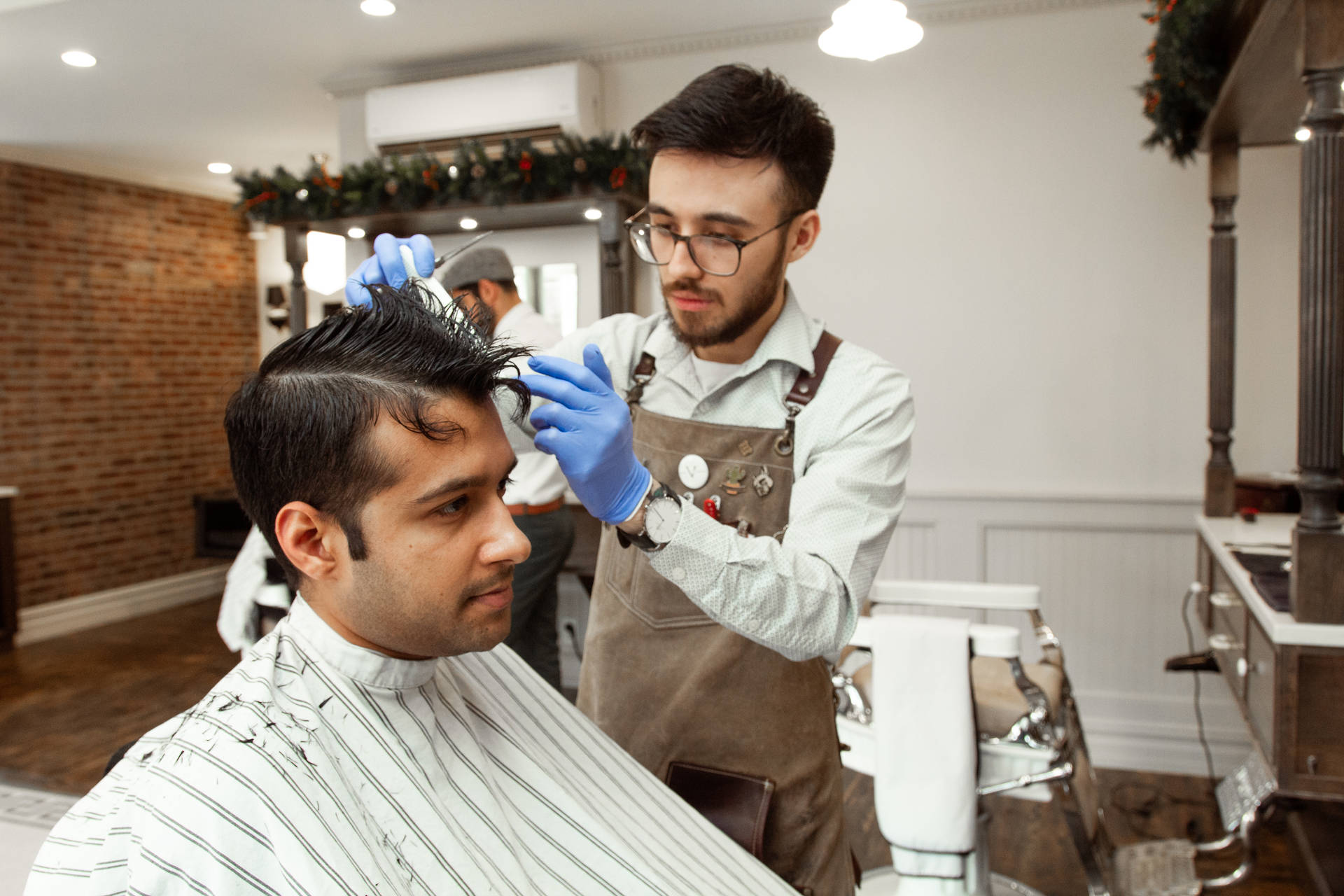 Hairdresser With Apron Performing Haircut