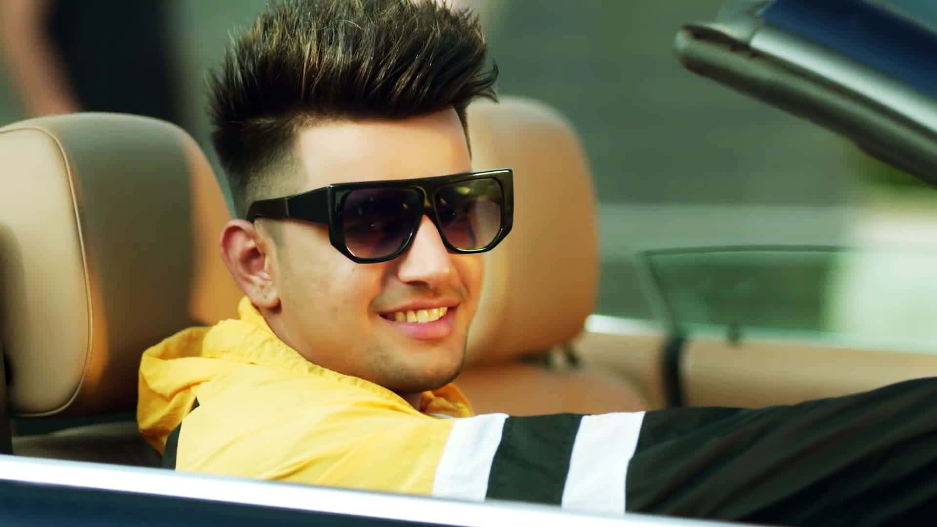 A Man In A Yellow Car With Sunglasses