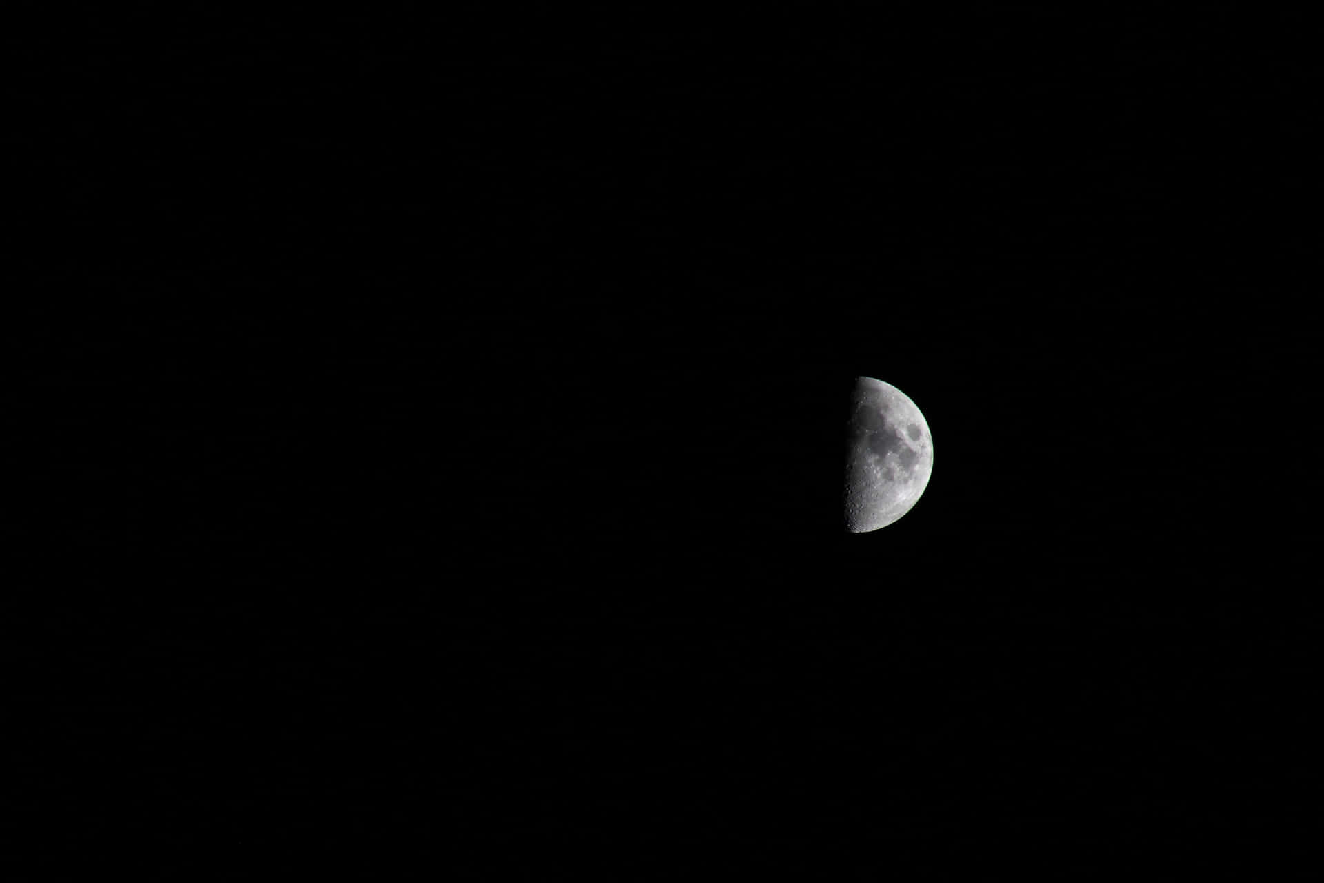 the moon is seen in the dark sky